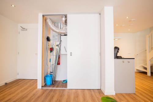 a room with a white wall and a door at Exclusive 70m2 One-Bedroom Apartment - WE39E in Tiel