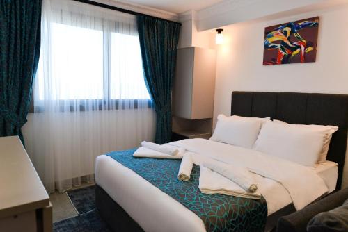 a hotel room with a bed with towels on it at Luxuriant Houses Kyrenia in Kérynia