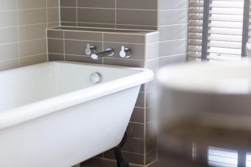 a bathroom with a white sink and a toilet at Aysgarth Falls Hotel & Restaurant in Aysgarth
