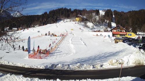 a group of people skiing down a snow covered slope at Chalet Giusto in Kötschach