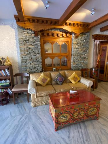 a living room with a couch and a table at Three Jewels Boutique Hotel in Pokhara