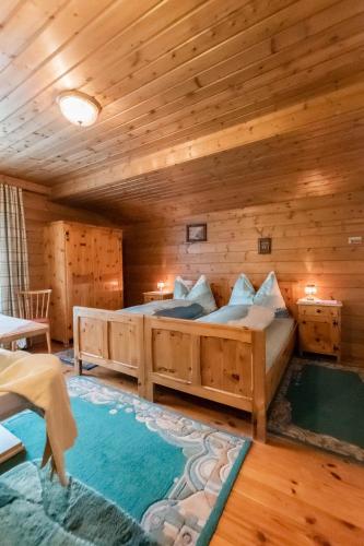 a bedroom with two beds in a log cabin at Ferienwohnung Hartlgut in Bad Hofgastein