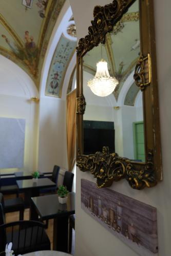 a mirror hanging on a wall in a restaurant at Il Salotto della Regina in Naples