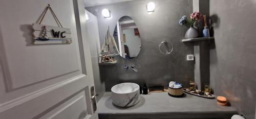 a bathroom with a sink and a mirror at Gabriel House in Monolithos