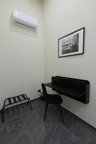 a room with a black piano and a chair at Il Salotto della Regina in Naples