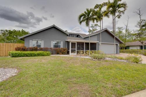 a house with palm trees in front of a yard at Spacious Wellington Vacation Rental - Private Pool in Wellington