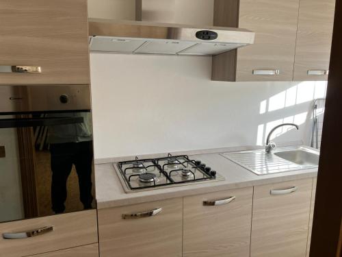 a kitchen with a stove and a sink at Luna Apartment in Rimini