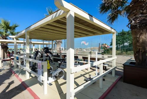 a gym with a roof and tread machines at Luna Apartment in Rimini