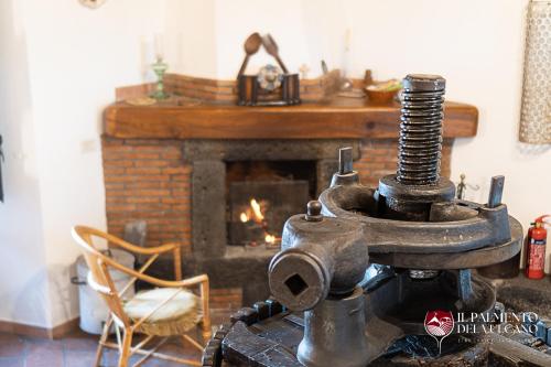 an old sewing machine in a living room with a fireplace at Chalet il Palmento del Vulcano in Bronte