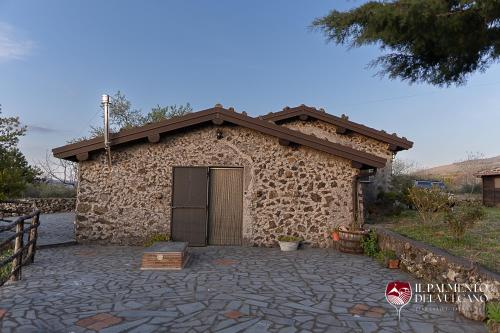 a stone building with a large door on it at Chalet il Palmento del Vulcano in Bronte
