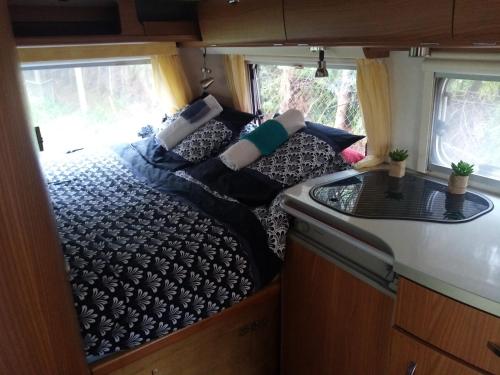 a couch in the back of an rv at Havre de paix au bords de l'Eure - divers hébergements in Neuilly
