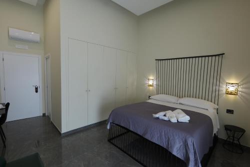 a bedroom with a bed with two towels on it at Il Salotto della Regina in Naples