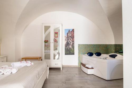 Un baño con dos camas y bañera. en Porta Nazionale Dependance, en Noto
