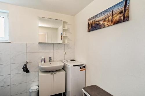 a small white bathroom with a sink and a counter at Zeiser in Pfullendorf