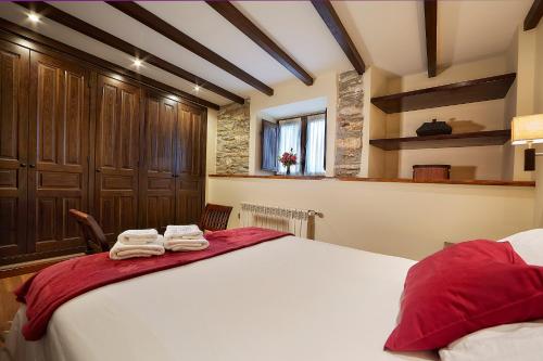 a bedroom with a large bed with towels on it at La Era De Somao in Somado