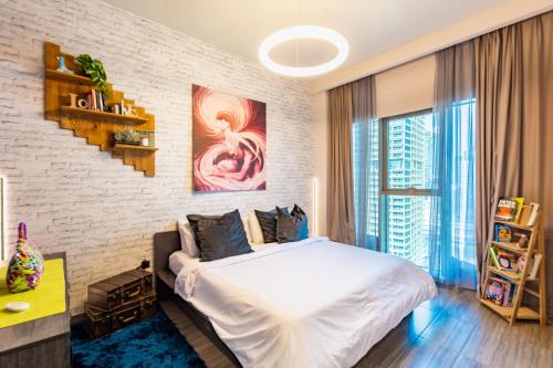 a bedroom with a white bed and a brick wall at VayK - Stylish One Bedroom near Marina with Full Lake View in Dubai