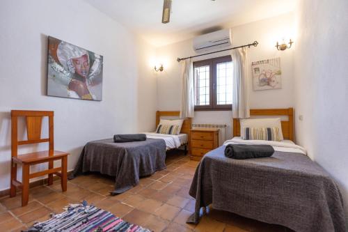 a room with two beds and a window at Villa Miguel in Sant Rafael de Sa Creu