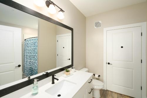 a bathroom with a white sink and a large mirror at Atlanta’s Summerhill Stay in Atlanta