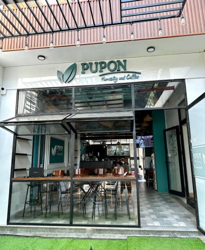 a restaurant with a table and chairs in front of it at PUPON Homestay and Coffee in Quang Ngai
