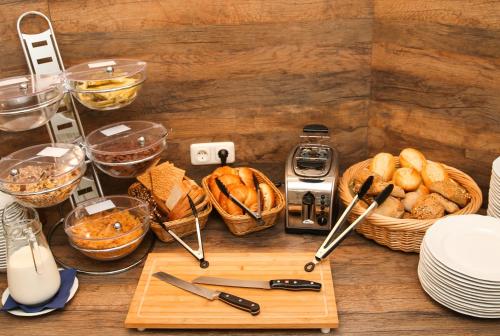 a table topped with baskets of bread and other foods at Hotel Esplanade Garni in Kühlungsborn