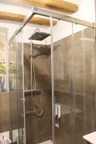 a shower with a glass door in a bathroom at CA LA MUM in Tivissa