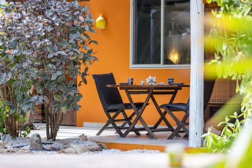 a table and two chairs in front of a building at Tropical Divers Resort in Kralendijk