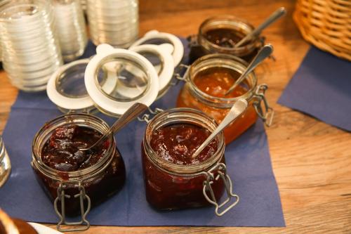a group of four jars of jam on a table at Hotel Esplanade Garni in Kühlungsborn