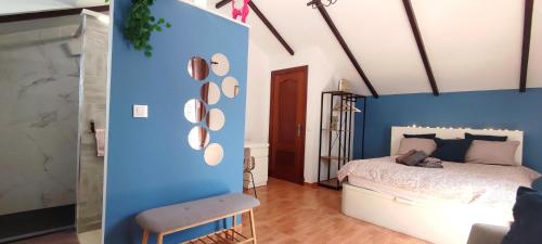Un dormitorio con una pared de acento azul y una cama en casa de vicky en El Puerto de Santa María