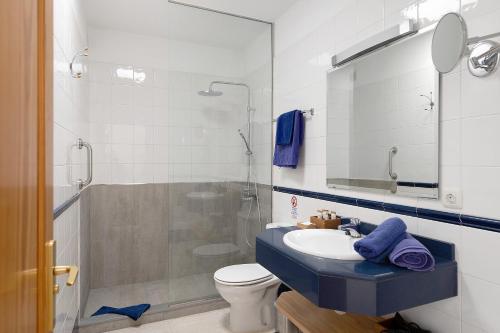 a bathroom with a toilet and a sink and a shower at Callao Beach 9 in Arrieta