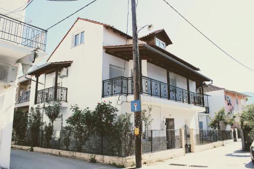 a white building with a fence in front of it at Dreamer's Home Chrisa in Limenas