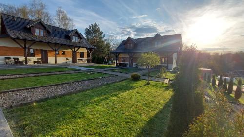 a house with a yard in front of it at Słoneczna Polana in Solina