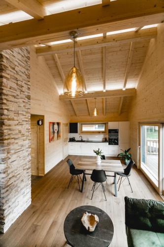 a large living room with a table and chairs at Chalet 49 Nesselgraben - Ferienwohnungen aus Holz in Koppl