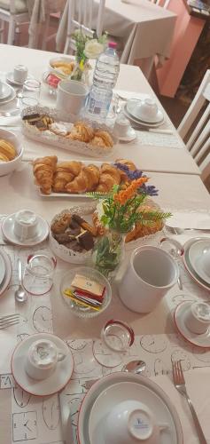 a table topped with plates and bowls of food at Andrea affittacamere e B&B in Solignano Nuovo