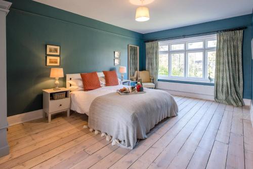 a bedroom with a bed and a large window at Hillcrest, Aldeburgh in Aldeburgh