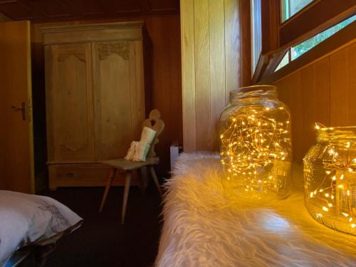 a jar filled with lights sitting on a bed at Appartamento sulle piste - Casa Folgarida in Folgarida
