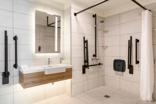 a bathroom with a sink and a shower at Courtyard by Marriott Glasgow SEC in Glasgow