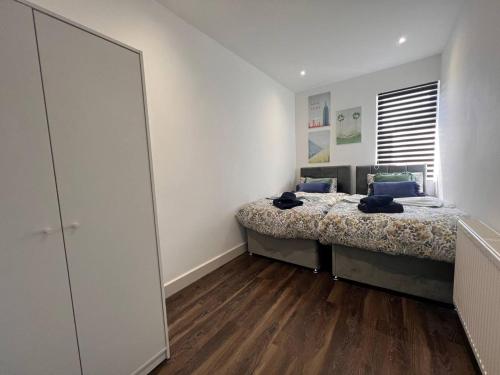 a bedroom with a bed and a large mirror at Star London Finchley Road 2-Bed Residence in London