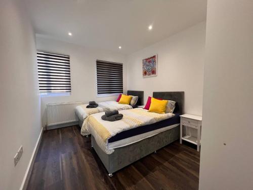 a bedroom with two beds and a window at Star London Finchley Road 2-Bed Residence in London