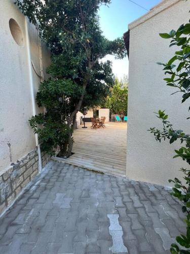a brick walkway leading to a patio with a building at "Le nature" Camargue Jardin in Arles