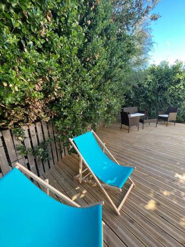 a blue chair sitting on top of a wooden deck at "Le nature" Camargue Jardin in Arles