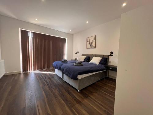 a bedroom with a bed and a large window at Star London Finchley Road 3-Bed Escape with Garden in London
