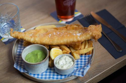 a plate of fish and french fries and dip at Aysgarth Falls Hotel & Restaurant in Aysgarth