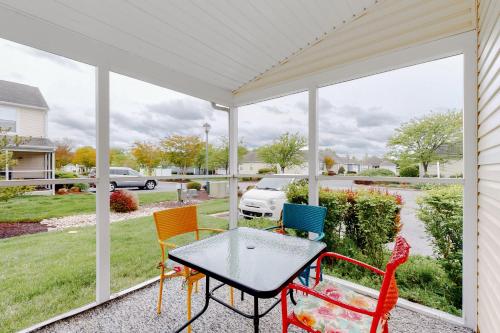 a screened porch with a table and chairs at Keys of Marsh Harbor Truman Ct in Rehoboth Beach