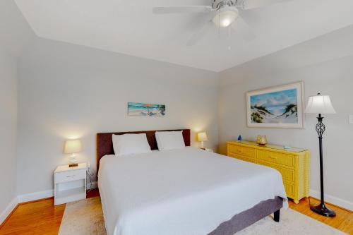 a bedroom with a white bed and a yellow dresser at Keys of Marsh Harbor Truman Ct in Rehoboth Beach
