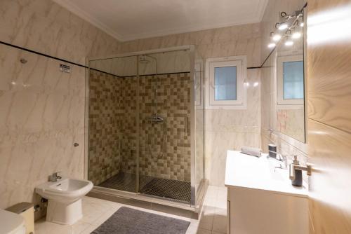 a bathroom with a shower and a toilet and a sink at Villa Roberto Ibiza in Sant Josep de Sa Talaia