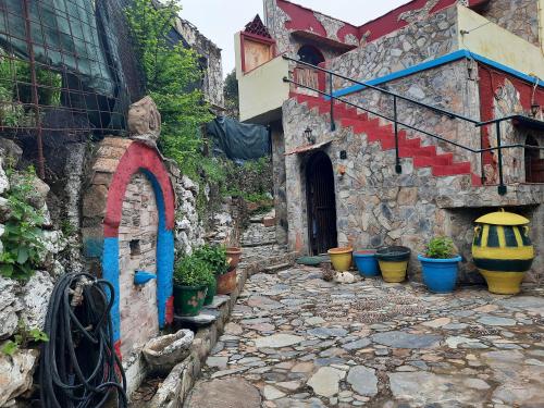 a stone alley with potted plants and a building at Kastania..2 in Kiolianá
