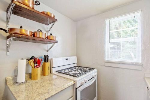 a kitchen with a stove top oven next to a window at Affordable for long stay great for travel workers in Oklahoma City