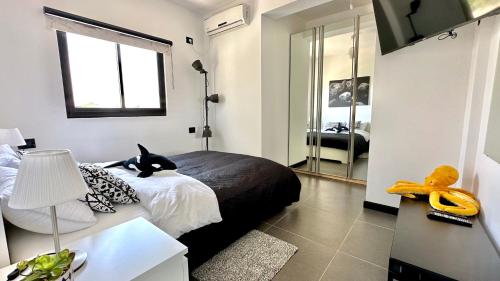 a bedroom with a black cat sitting on a bed at GW945 Gugel Waves Amazing Seaview Apartments in Nahariyya