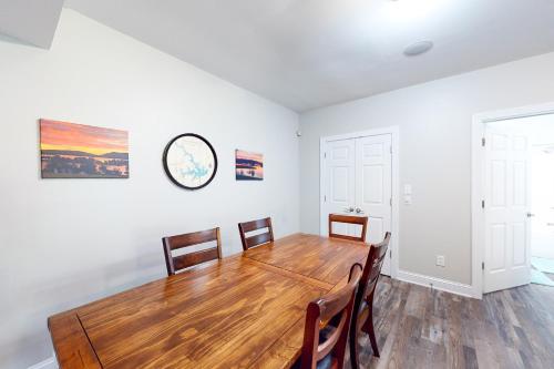 a dining room with a wooden table and chairs at Emerald Cove in Moneta