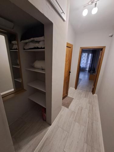 a room with a closet with shelves and a hallway at Studio Demokratsia in Burgas City